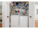 Laundry room with washer and dryer, plus shelving, offers a functional and organized space at 1327 Hedgewood Cir, North Port, FL 34288