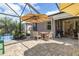 Screened pool deck features seating, dining, and a grill at 1327 Hedgewood Cir, North Port, FL 34288
