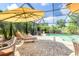 Outdoor screened pool features multiple seating and lounge areas at 1327 Hedgewood Cir, North Port, FL 34288
