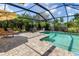 Gorgeous screened pool and paver patio with outdoor seating, ideal for enjoying sunny days at 1327 Hedgewood Cir, North Port, FL 34288