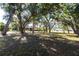 A spacious backyard with mature trees providing shade and privacy for outdoor activities and relaxation at 14534 Keene Ave, Port Charlotte, FL 33953
