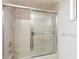 Bathroom featuring a shower with glass doors at 14534 Keene Ave, Port Charlotte, FL 33953