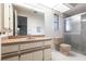 Cozy bathroom features a vanity, toilet, and a glass-enclosed walk-in shower at 14534 Keene Ave, Port Charlotte, FL 33953