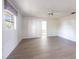Bright bedroom features wood-look floors, a ceiling fan, and a window for natural light at 14534 Keene Ave, Port Charlotte, FL 33953