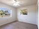 Well-lit bedroom with wood-look floors and dual window views at 14534 Keene Ave, Port Charlotte, FL 33953