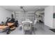 Bright garage area with lawn equipment and table with chairs at 14534 Keene Ave, Port Charlotte, FL 33953