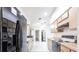 The kitchen features modern appliances, ample counter space, and light wood cabinetry with views to the backyard at 14534 Keene Ave, Port Charlotte, FL 33953