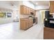 The kitchen features a microwave, oven, and plenty of cabinet space. The kitchen connects to the Gathering room at 14534 Keene Ave, Port Charlotte, FL 33953