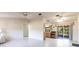 Open living area features tile flooring and flows into the kitchen with sliding glass doors leading to the patio at 14534 Keene Ave, Port Charlotte, FL 33953