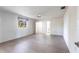 A spacious main bedroom featuring a ceiling fan, wood-look flooring, and a window offering natural light at 14534 Keene Ave, Port Charlotte, FL 33953