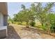 The lush backyard features trees and landscaping at 1513 Urmey Ln, North Port, FL 34286