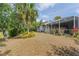 Serene backyard showcasing a screened lanai perfect for outdoor living and shaded relaxation at 1513 Urmey Ln, North Port, FL 34286