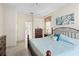 Bedroom view showcasing a queen bed, dresser, and ensuite bathroom entrance at 1513 Urmey Ln, North Port, FL 34286