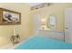 Bright bedroom with decorative shelves, white dresser, and a colorful painting at 1513 Urmey Ln, North Port, FL 34286