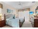 Bedroom featuring an iron bed frame, light blue bedding, and bright natural light at 1513 Urmey Ln, North Port, FL 34286