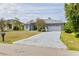 Charming single-story home featuring a two-car garage, well-maintained lawn, and inviting curb appeal at 1513 Urmey Ln, North Port, FL 34286