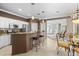 Open-concept kitchen featuring stainless steel appliances, granite countertops, and breakfast bar seating at 1513 Urmey Ln, North Port, FL 34286
