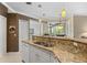 Functional kitchen featuring a breakfast bar, granite counters, and an open layout at 1513 Urmey Ln, North Port, FL 34286