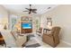 Cozy living room featuring arched windows, plantation shutters, and comfortable seating at 1513 Urmey Ln, North Port, FL 34286