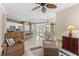 Open-concept living space with kitchen view and comfortable seating, flooded with natural light at 1513 Urmey Ln, North Port, FL 34286