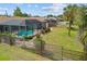 Backyard features a pool and meticulous landscaping, surrounded by a wooden fence for added privacy at 158 Norman St, Port Charlotte, FL 33954
