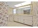Bathroom featuring floral wallpaper, a double sink vanity, and tile flooring at 158 Norman St, Port Charlotte, FL 33954