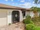 Charming front entrance with decorative door, stone accents, and lush landscaping providing great curb appeal at 158 Norman St, Port Charlotte, FL 33954