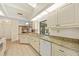 Bright kitchen features skylight, granite counters, and pool view from sliding glass doors at 158 Norman St, Port Charlotte, FL 33954