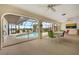 Covered lanai featuring a screened-in pool with views of the lake, along with a dining area for outdoor entertaining at 158 Norman St, Port Charlotte, FL 33954