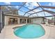 Backyard view of a large screened-in pool with ample patio space for lounging and outdoor entertaining at 158 Norman St, Port Charlotte, FL 33954