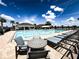 Inviting community pool with plenty of chairs and tables for residents to enjoy at 16909 Caracara Pl, Punta Gorda, FL 33982