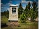 Community entrance sign amidst lush greenery and mature trees, marking Babcock Preserve at 16909 Caracara Pl, Punta Gorda, FL 33982