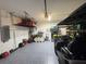 Spacious garage with speckled floors, overhead storage, and room for a golf cart at 16909 Caracara Pl, Punta Gorda, FL 33982