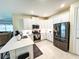 Modern kitchen with white cabinets, stainless steel appliances, and a center island at 16909 Caracara Pl, Punta Gorda, FL 33982