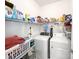 Well-organized laundry room with washer, dryer, storage shelves, and laundry supplies at 16909 Caracara Pl, Punta Gorda, FL 33982