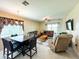 Cozy living and dining area featuring tile flooring, ceiling fans, and a comfortable seating arrangement at 16909 Caracara Pl, Punta Gorda, FL 33982