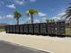 Row of community mailboxes under a clear blue sky lined with palm trees at 16909 Caracara Pl, Punta Gorda, FL 33982