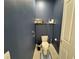 This powder room features blue painted walls, a white toilet, and tiled flooring at 16909 Caracara Pl, Punta Gorda, FL 33982