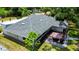 Aerial view showcasing a home with mature trees, a brick patio and grill, and well-maintained landscaping at 22498 Westchester Blvd, Punta Gorda, FL 33980