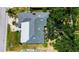 Aerial view highlighting the home's roof, patio, landscaping, and surrounding greenery at 22498 Westchester Blvd, Punta Gorda, FL 33980