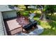 Backyard with a brick patio, well-maintained lawn, mature trees, and outdoor seating at 22498 Westchester Blvd, Punta Gorda, FL 33980