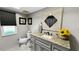 The bathroom showcases a granite countertop, stylish mirror, and modern fixtures, creating a spa-like experience at 22498 Westchester Blvd, Punta Gorda, FL 33980