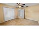 This bright bedroom features tile floors, a ceiling fan, and a double closet for ample storage space at 22498 Westchester Blvd, Punta Gorda, FL 33980