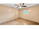 Empty bedroom with tile floors, a ceiling fan, and a window offering natural light at 22498 Westchester Blvd, Punta Gorda, FL 33980