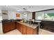 Spacious kitchen bar with dark wood cabinetry, granite countertops, and breakfast bar seating at 22498 Westchester Blvd, Punta Gorda, FL 33980