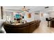Comfortable living room with a brick TV stand, leather seating, and tiled floors at 22498 Westchester Blvd, Punta Gorda, FL 33980