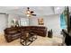 Comfortable living room with a plush sectional sofa, modern decor, and a view into the adjacent kitchen at 22498 Westchester Blvd, Punta Gorda, FL 33980