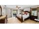 This main bedroom features tile flooring, a ceiling fan, dresser, and sliding glass doors to the porch, for easy access at 22498 Westchester Blvd, Punta Gorda, FL 33980