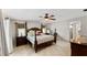 Spacious main bedroom boasting tile flooring, ceiling fan, and room for dressers, offering a peaceful retreat at 22498 Westchester Blvd, Punta Gorda, FL 33980