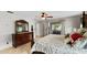 Serene main bedroom with tile flooring, a ceiling fan, dresser, and sliding glass door access to porch, creating a retreat at 22498 Westchester Blvd, Punta Gorda, FL 33980